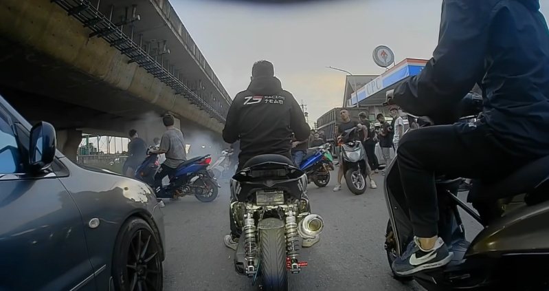 桃園市觀音區西濱路四段今凌晨出現大批改裝車,不僅沒有安裝號牌,騎士也皆未戴安全帽,囂張占用道路競速,改裝排氣管排出大量煙霧迷漫現場。記者周嘉茹/翻攝 桃園市觀音區西濱路四段今凌晨出現大批改裝車,不僅沒有安裝號牌,騎士也皆未戴安全帽,囂張占用道路競速,改裝排氣管排出大量煙霧迷漫現場。記者周嘉茹/翻攝
