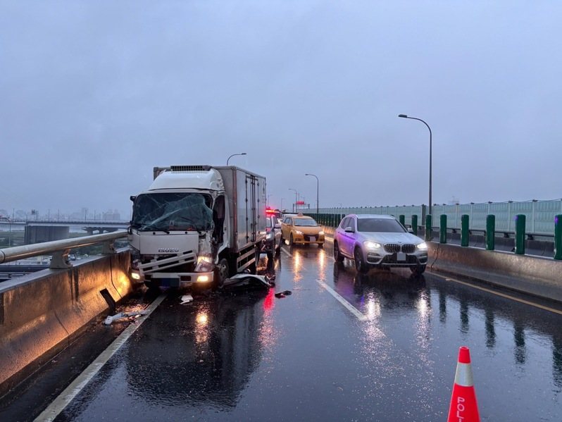台64線快速道路三重路段往八里方向，凌晨4時許有1輛貨車自撞護欄翻車，導致後方另2輛貨車發生追撞，1人受傷送醫，並造成西向交通完全中斷約1個小時無法通行。記者林昭彰／翻攝