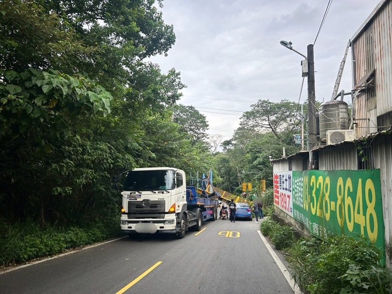 新北市一輛聯結車今天下午行經新莊區壽山路，疑因載運「貨運玻璃鐵架」過高撞斷限高架，所幸沒人受傷，肇因待查。記者曾伯愷／翻攝