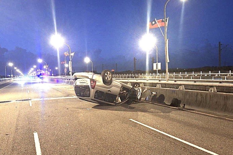 行駛中的機車掉落安全帽，帽子在路面滾跳，左方轎車為閃避自撞蘭陽橋護欄並翻車，四輪朝天。圖／警方提供