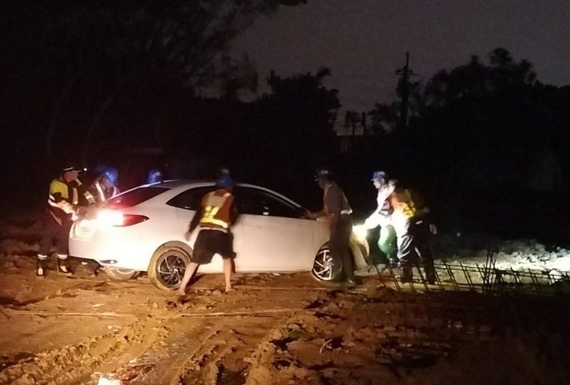 桃園蘆竹一名彭姓男子近日開車行經航空城用地,因天色昏暗不慎駛進泥濘動彈不得,警方獲報後到場與附近工程人員一同拖出車輛。記者周嘉茹/翻攝 桃園蘆竹一名彭姓男子近日開車行經航空城用地,因天色昏暗不慎駛進泥濘動彈不得,警方獲報後到場與附近工程人員一同拖出車輛。記者周嘉茹/翻攝